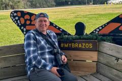 Traveler with camera enjoying the wildlife atmosphere at Brazos Bend State Park near Houston, Texas.