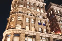 Historic building facade next to modern skyscrapers in Downtown Dallas