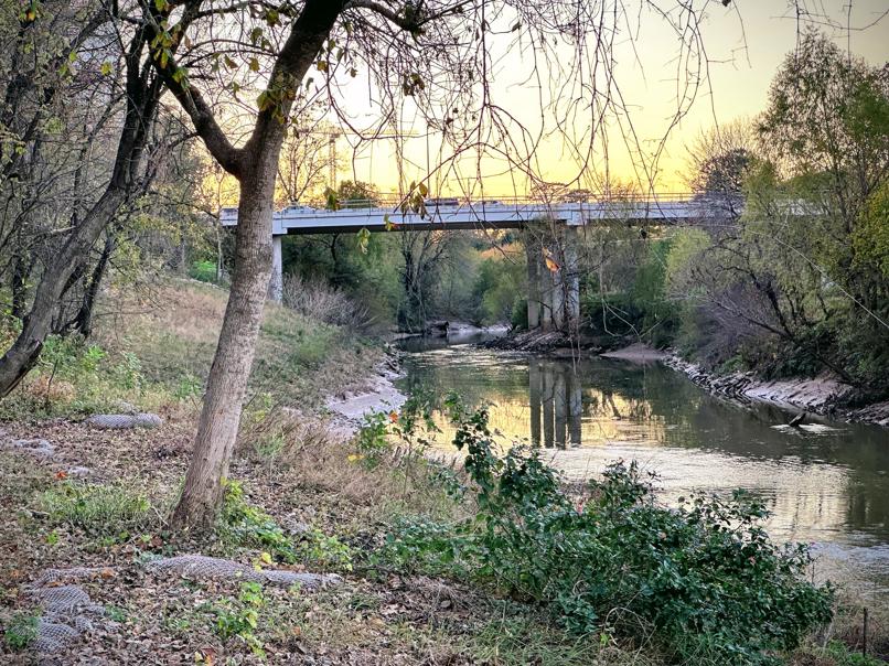 Buffalo Bayou Park sunset over river and bridge in Houston