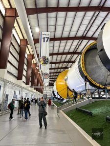 Saturn V rocket inside NASA hangar with Apollo 17 banner in Houston