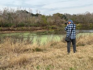 Photographer capturing wetlands scenery in Brazos Bend State Park near Houston Texas