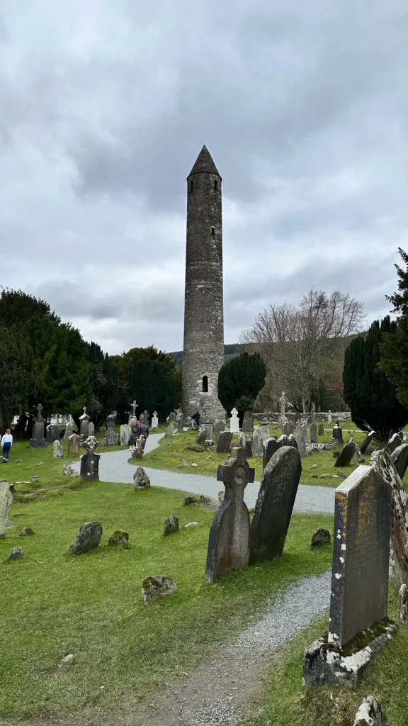 Glendalough round tower rising above monastery ruins
