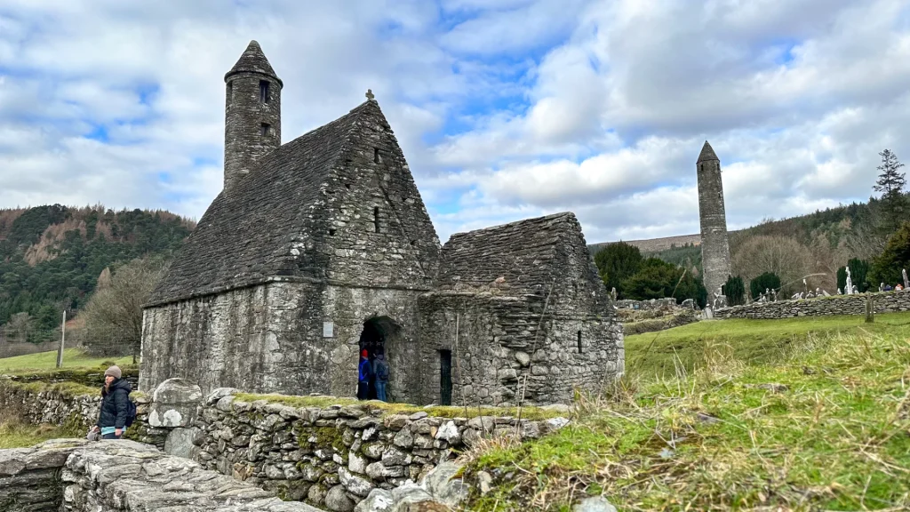 Glendalough round tower rising above monastery ruins