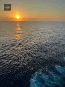 Bright sunrise above the ocean horizon during cruise
